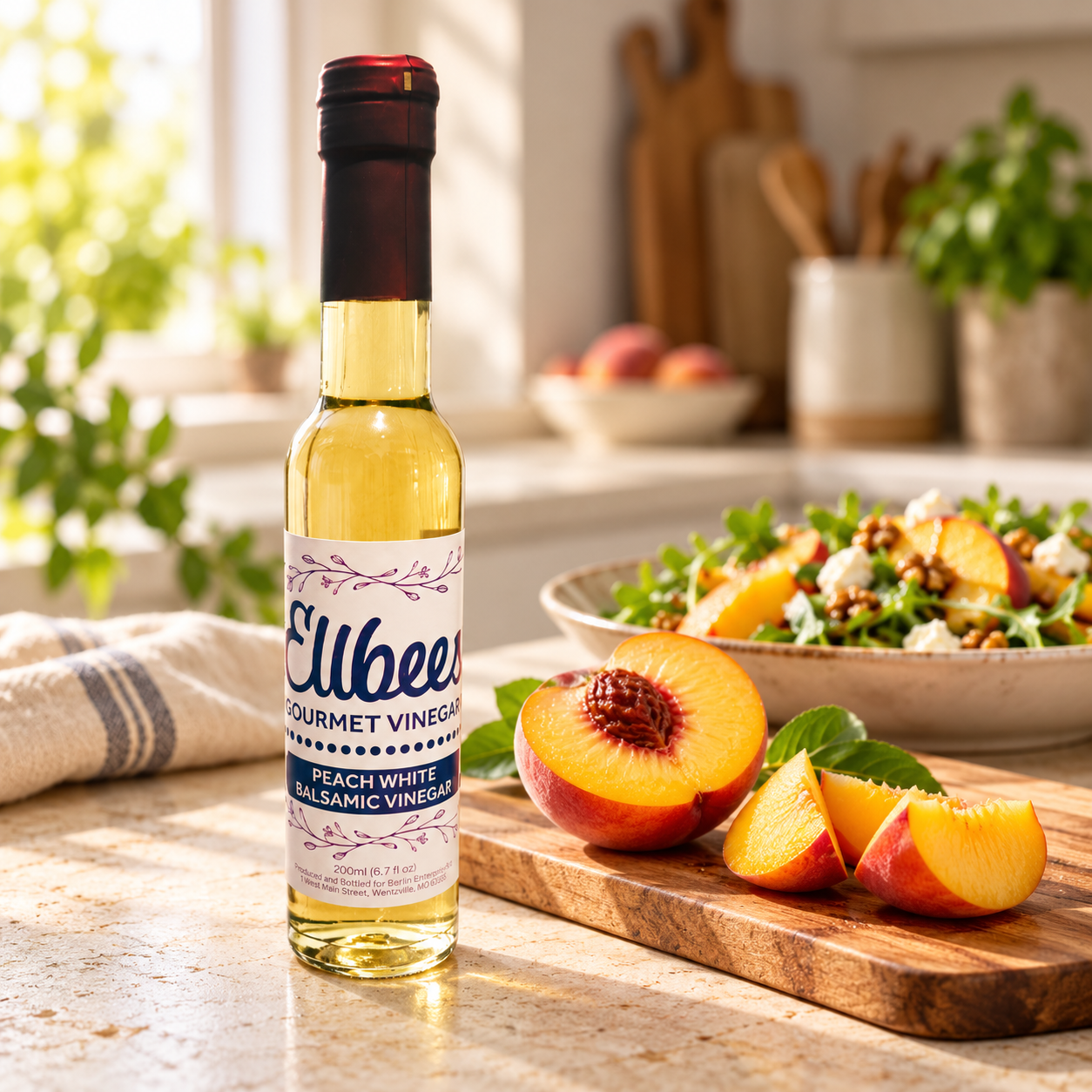 Ellbee’s Peach White Balsamic Vinegar bottle with serving suggestions on a kitchen countertop