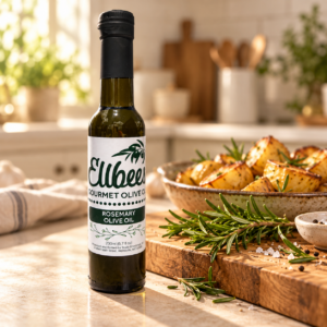 Ellbee’s Rosemary Olive Oil bottle with serving suggestions on a kitchen countertop